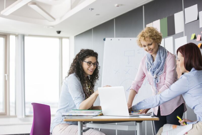 Businesswomen Working Together In Creative Office - Achieve More